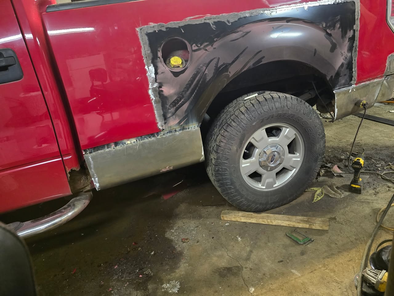 New metal fitted and welded into the pickup bedside during rust repair
