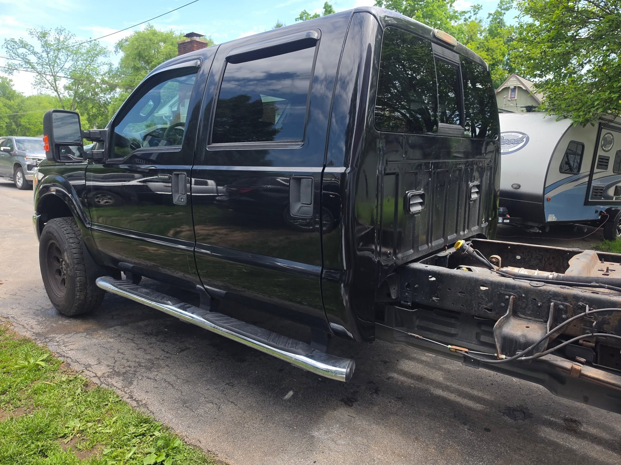 Black Ford Super Duty with the bed removed to expose the cab and frame